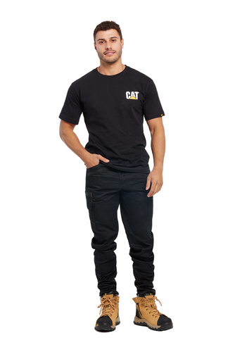 Man wearing a black t-shirt with a logo, black pants, and brown boots on a white background